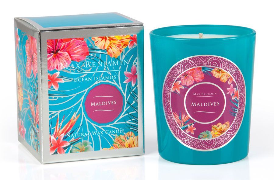 Turquoise candle with a floral design, housed in a glass jar, accompanied by a colorful box featuring tropical flowers and the label "Maldives."