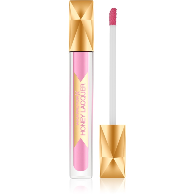 Max Factor Honey Lacquer in shade 15 Honey Lilac features a clear tube with a gold geometric cap and a pink applicator wand, showcasing a glossy, soft pink lip color.
