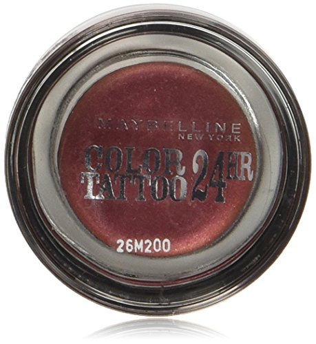 Metallic pomegranate cream eyeshadow in a clear jar with a black lid, featuring "Maybelline Color Tattoo 24hr" branding and a shade label on the bottom.