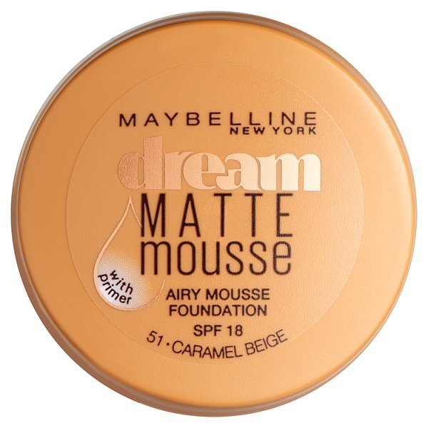Maybelline Dream Matte Mousse Foundation in a round, orange container with a gold label, featuring "Dream" and "Matte Mousse" text, and indicating SPF 18 and shade 51 Caramel Beige.