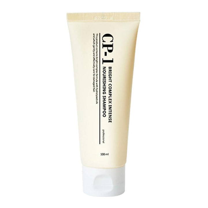 Cream-colored tube labeled "CP-1 Bright Complex Intense Nourishing Shampoo," featuring black text and a 100ml capacity, with a minimalist design.