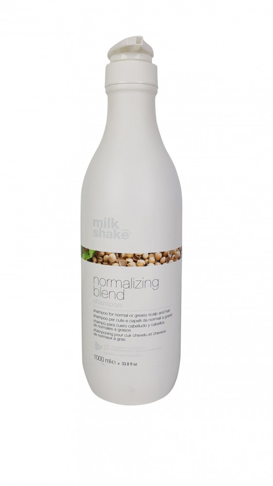 White plastic bottle with a pump top, labeled "Normalizing Shampoo Milk Shake Blend 1000 Ml" featuring a natural ingredient graphic and a clean, minimalist design.
