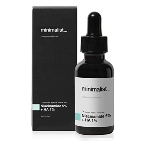 Clear glass dropper bottle with a black lid, labeled "Minimalist Niacinamide 5% + HA 1%", alongside a sleek black box featuring the same branding.