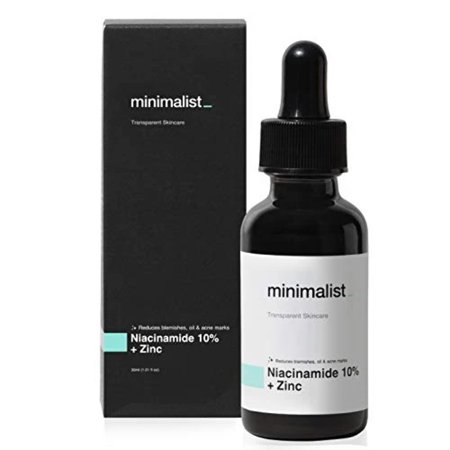 A black bottle with a dropper cap contains a clear serum labeled "Niacinamide 10% + Zinc," alongside a sleek black box featuring minimalist branding.