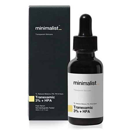 Clear glass dropper bottle with black lid, labeled "Minimalist Tranexamic 03% Face Serum," accompanied by a sleek black box featuring minimalist design elements.