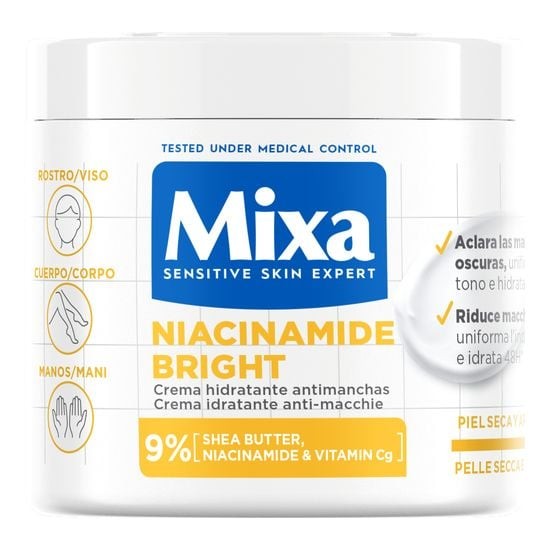 White jar with a blue lid labeled "Mixa Niacinamide Bright Anti-Stain Cream," featuring key ingredients like shea butter and vitamin C, designed for dry and dull skin.