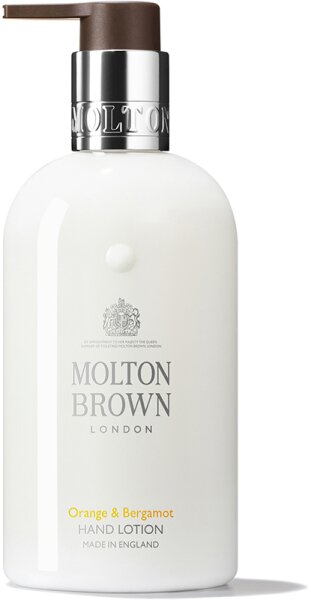 White bottle of Molton Brown Orange and Bergamot Hand Lotion, featuring a brown pump top, silver logo, and elegant text, 300ml size, made in England.