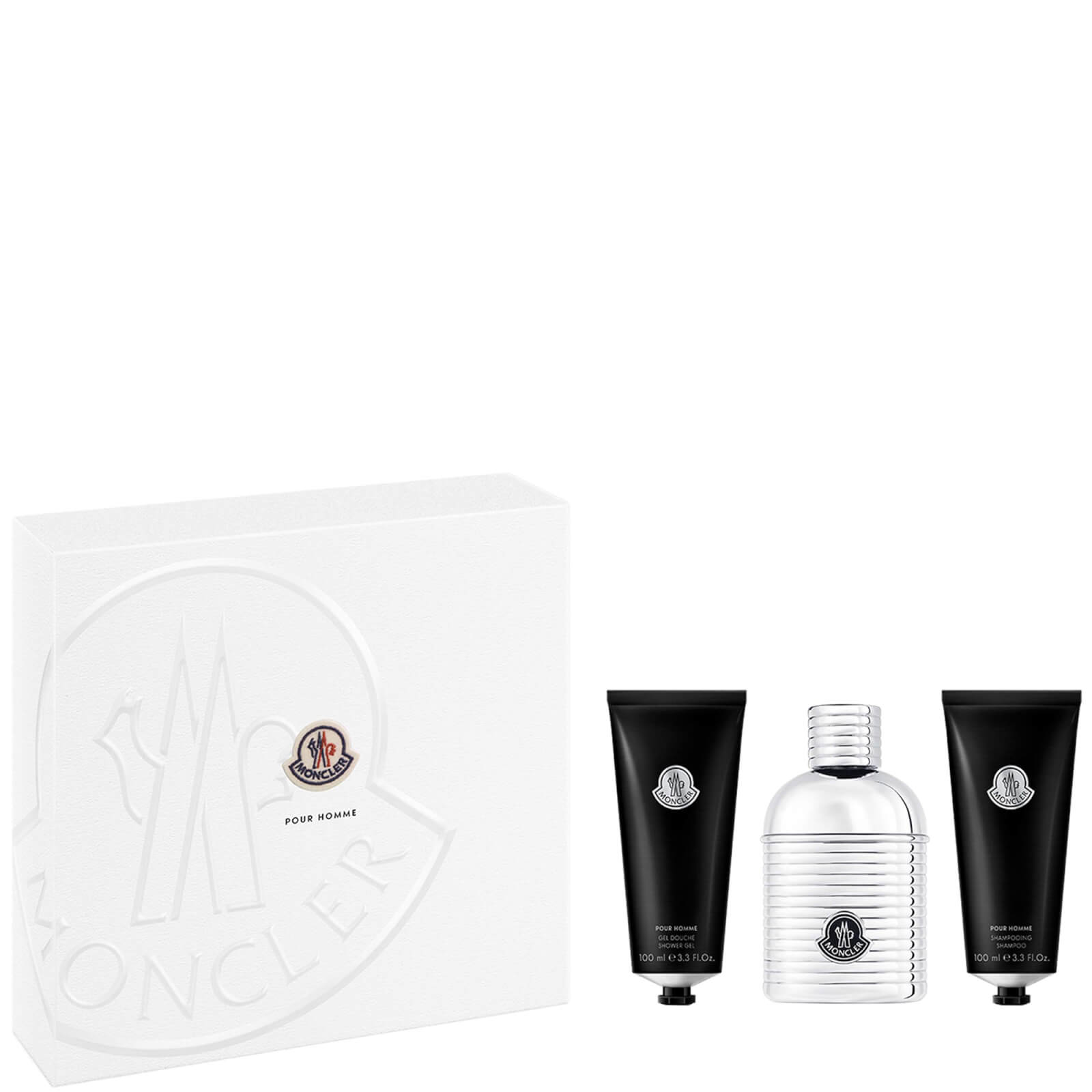 Moncler Pour Homme gift set featuring a sleek silver 100ml EDP bottle and two black 100ml tubes of shower gel and shampoo, all presented in a white box with embossed logo.