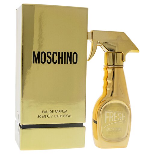 Gold-colored bottle shaped like a spray cleaner with a trigger nozzle, alongside a matching gold box, both featuring the Moschino logo and "FRESH" text.