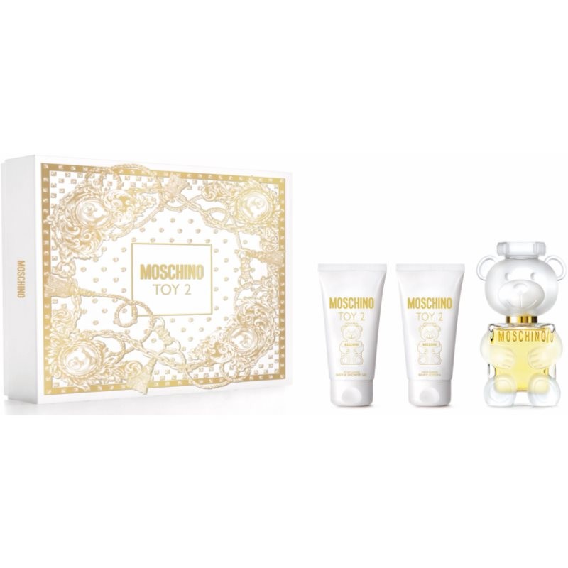 Moschino Toy 2 gift set featuring a 50ml EDP in a teddy bear-shaped bottle, alongside 50ml body lotion and shower gel in white tubes, all presented in a gold-accented box.