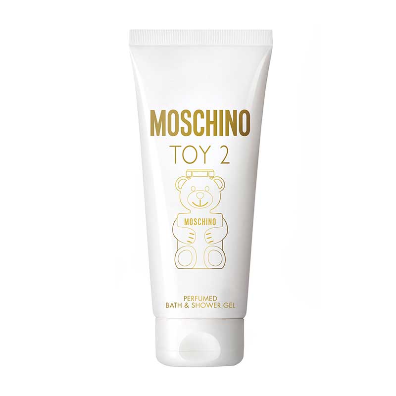 White tube of Moschino Toy 2 bath and shower gel, featuring a gold bear graphic and bold text, with a flip-top cap at the bottom.