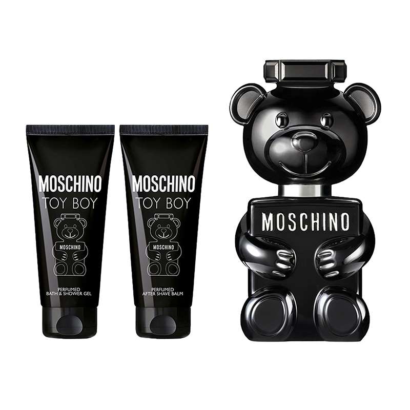 Black bear-shaped bottle of Moschino Toy Boy Eau De Parfum (50 ml) alongside two black tubes of aftershave balm and shower gel (50 ml each), all featuring playful branding.