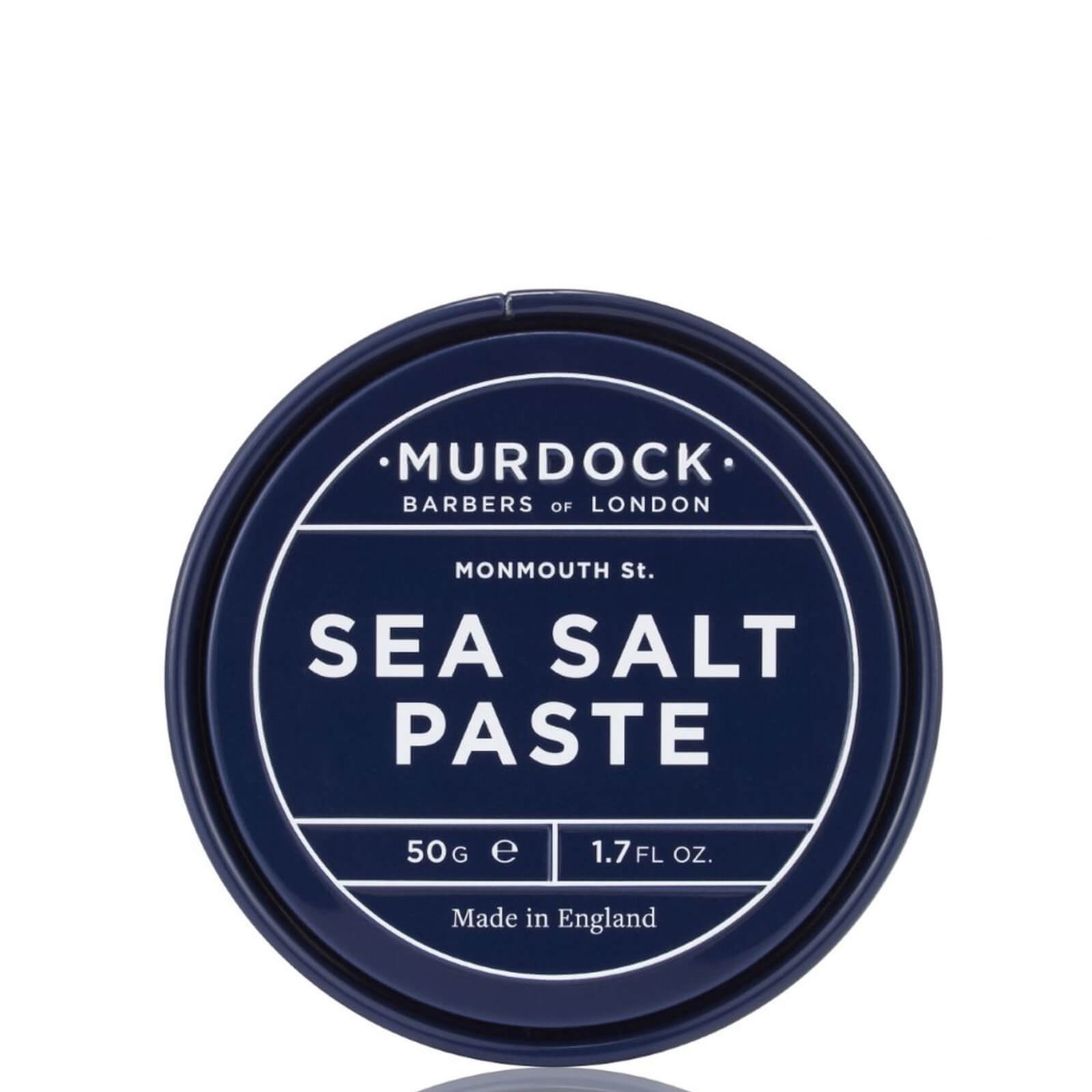 Navy blue tin container of Murdock London's Sea Salt Paste, labeled with white text, featuring a 50g capacity and "Barbers of London" branding.