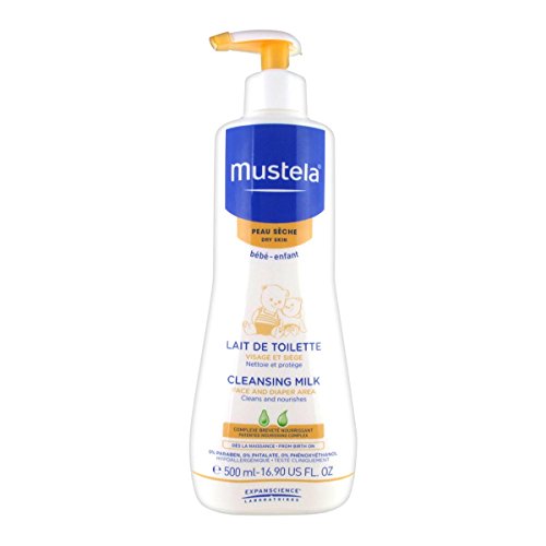 White plastic bottle with a pump dispenser, labeled "Mustela Cleansing Milk" in blue and yellow, 500 ml, designed for babies, featuring gentle cleansing and moisturizing properties.
