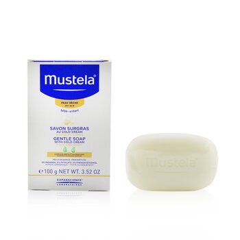 Mustela Gentle Soap with Cold Cream, 3.52 oz, features a creamy white bar beside a blue and white box, highlighting its moisturizing properties for sensitive skin.