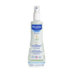 Clear plastic spray bottle with a white and blue label, featuring a chamomile flower design, containing 6.76 oz of hair styler and skin refreshener by Mustela.