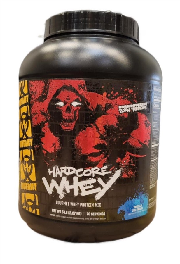 Black plastic container of Mutant Hardcore Whey protein powder, featuring a bold red and black design with a skull graphic, labeled "Vanilla Ice Cream," 2270g, 70 servings.