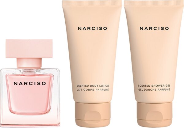 Narciso Rodriguez Cristal set featuring a pink glass perfume bottle and two beige tubes of moisturizing shower gel and body lotion, all labeled "Narciso."