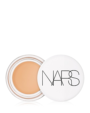 NARS Light Reflecting Eye Brightener in a sleek white container, featuring a creamy golden shade inside, ideal for brightening the under-eye area.