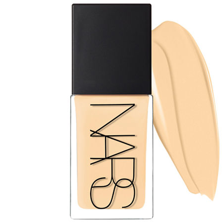 NARS Light Reflecting Foundation in Deauville, featuring a sleek glass bottle with a matte black cap, accompanied by a swatch of creamy beige foundation.