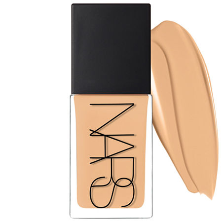 Nars Light Reflecting Foundation in Punjab features a sleek glass bottle with a black cap, showcasing a warm beige liquid foundation next to a swatch.