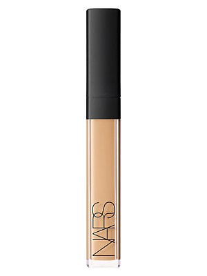 NARS Radiant Creamy Concealer in Creme Brulee, a 0.22 oz/6 ml tube with a sleek black cap and clear body showcasing a creamy beige product inside.