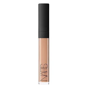 Nars Radiant Creamy Concealer in Honey features a sleek, transparent tube with a black cap, showcasing a creamy, warm beige shade ideal for concealing imperfections.