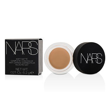 Nars Soft Matte Concealer in Crème Brûlée, featuring a creamy beige shade, housed in a sleek black container with a clear lid and white branding.