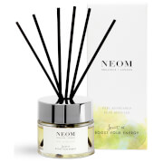 Clear glass reed diffuser with silver lid, black reeds, and a light green and yellow box featuring the NEOM logo, labeled "Feel Refreshed."