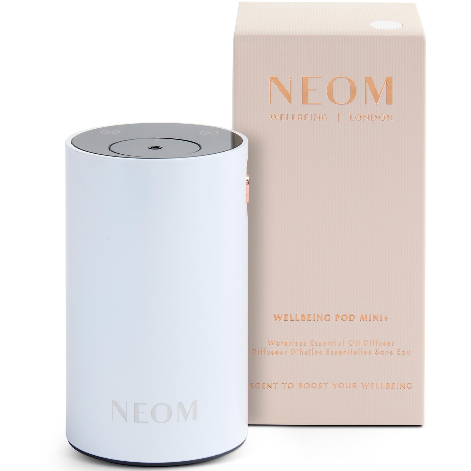 White cylindrical essential oil diffuser with a sleek design, featuring a touch control top, next to a beige box labeled "NEOM Wellbeing Pod Mini+."