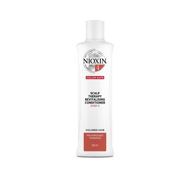 Nioxin System 4 Scalp Treatment conditioner in a white plastic bottle with a flip-top cap, featuring red and black accents and labeled for colored hair and progressive thinning.