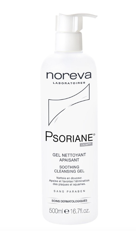 White plastic bottle of Noreva Psoriane Soothing Cleansing Gel, 500 ml, featuring a pump dispenser and minimalist design with black text and logo.
