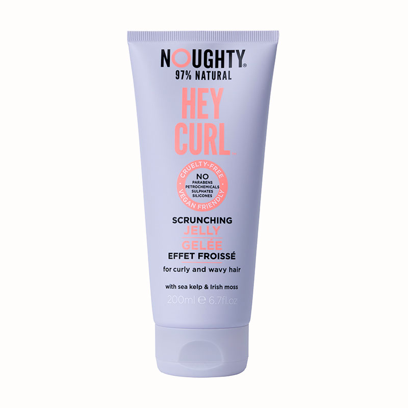 Light lavender tube with a flip-top cap, labeled "Noughty Hey Curl Scrunching Jelly 200 ml," featuring sea kelp and Irish moss, cruelty-free and 97% natural ingredients.