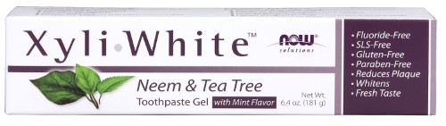 XyliWhite Neem & Tea Tree Toothpaste tube in a white box with purple accents, featuring mint flavor and labels indicating it's fluoride-free, gluten-free, and paraben-free.