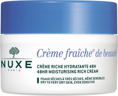 Nuxe Crème Fraîche de Beauté Rich Moisturizing Cream in a white jar with a blue lid, labeled for 48-hour hydration, suitable for dry and sensitive skin, 50ml size.