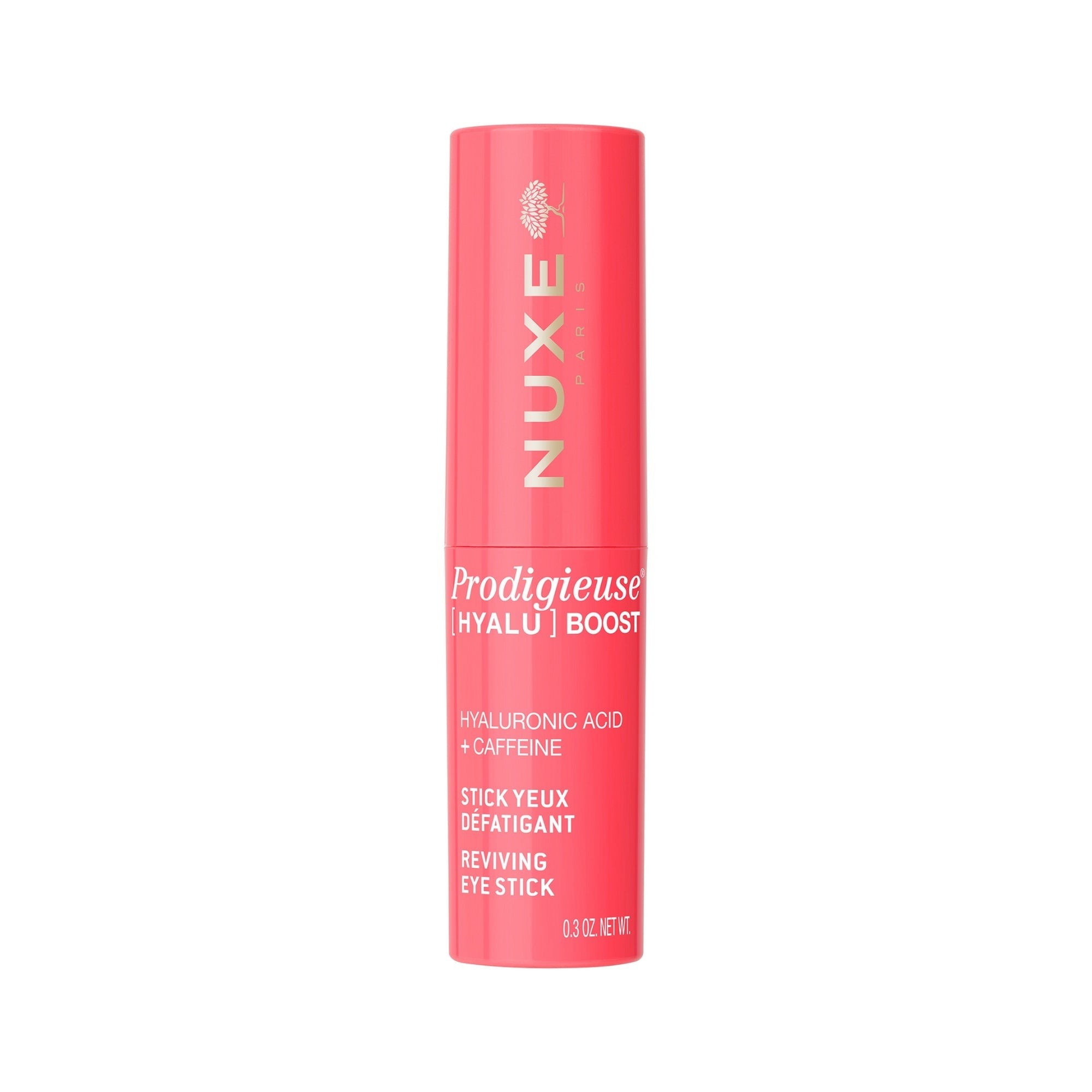 Bright pink cylindrical tube with gold lettering, labeled "NUXE Prodigieuse Hyalu | Boost," featuring "Reviving Eye Stick" and highlighting hyaluronic acid and caffeine.