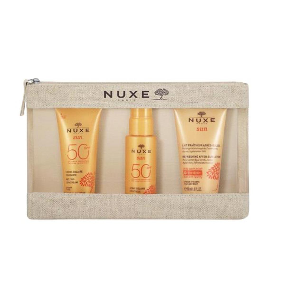 NUXE Sun Travel Kit featuring three golden sun care products in a transparent zippered pouch with a beige fabric exterior, ideal for sun protection on the go.
