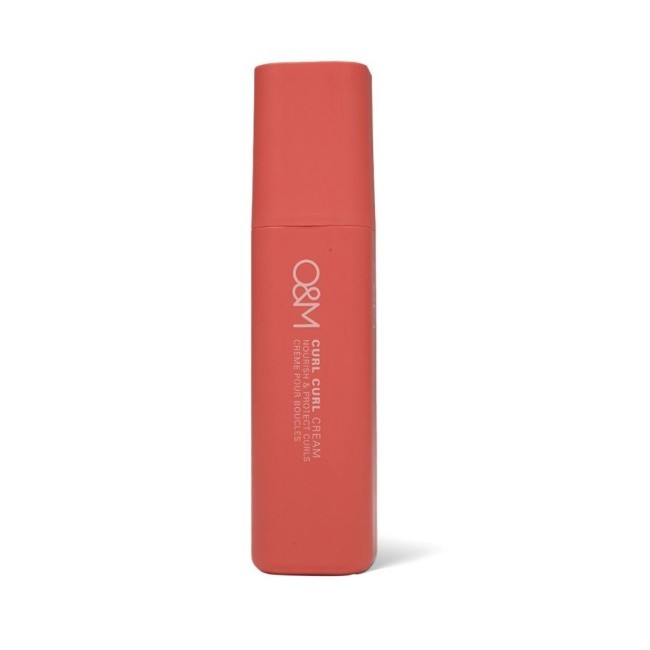 O&M Curl Curl Cream in a sleek coral tube, featuring a matte finish and a square cap, designed to infuse moisture for softness and bounce in curls.