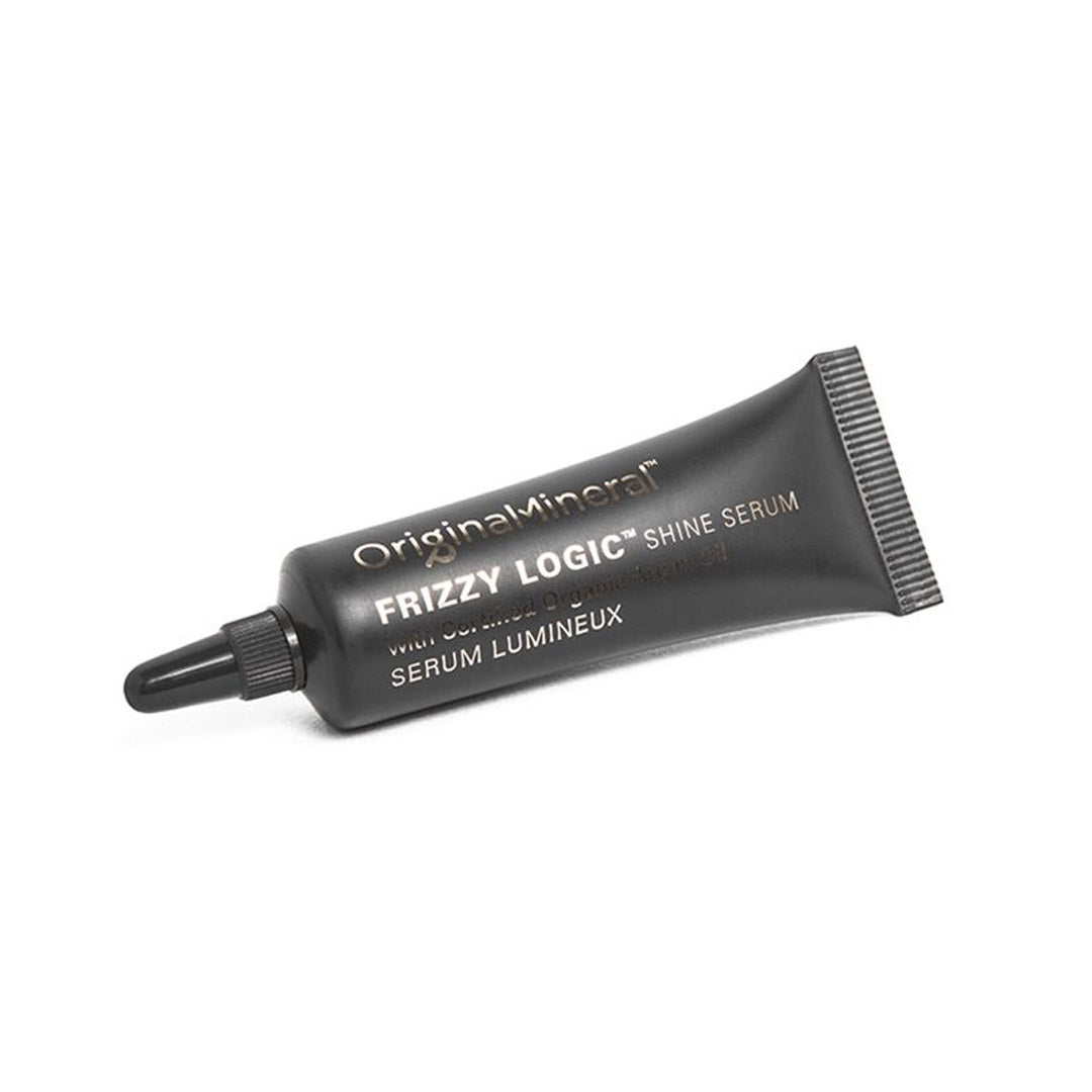 Black squeeze tube containing 10ml of O&M Frizzy Logic Hair Serum, featuring a pointed applicator tip and white text on the front, set against a white background.