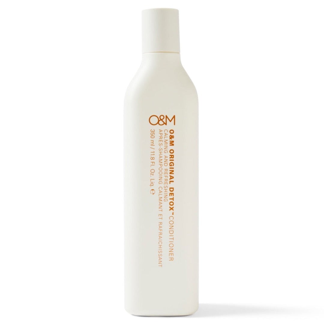 White bottle of O&M Original Detox Conditioner, 350ml, featuring orange text, with key ingredients like jojoba seed oil, designed to soothe, cool, and refresh hair.
