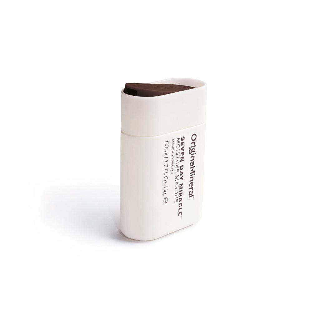 White and brown mini bottle of O&M Seven Day Miracle Moisturiser, featuring a sleek design, labeled with product details and ingredients like coconut and macadamia oil.