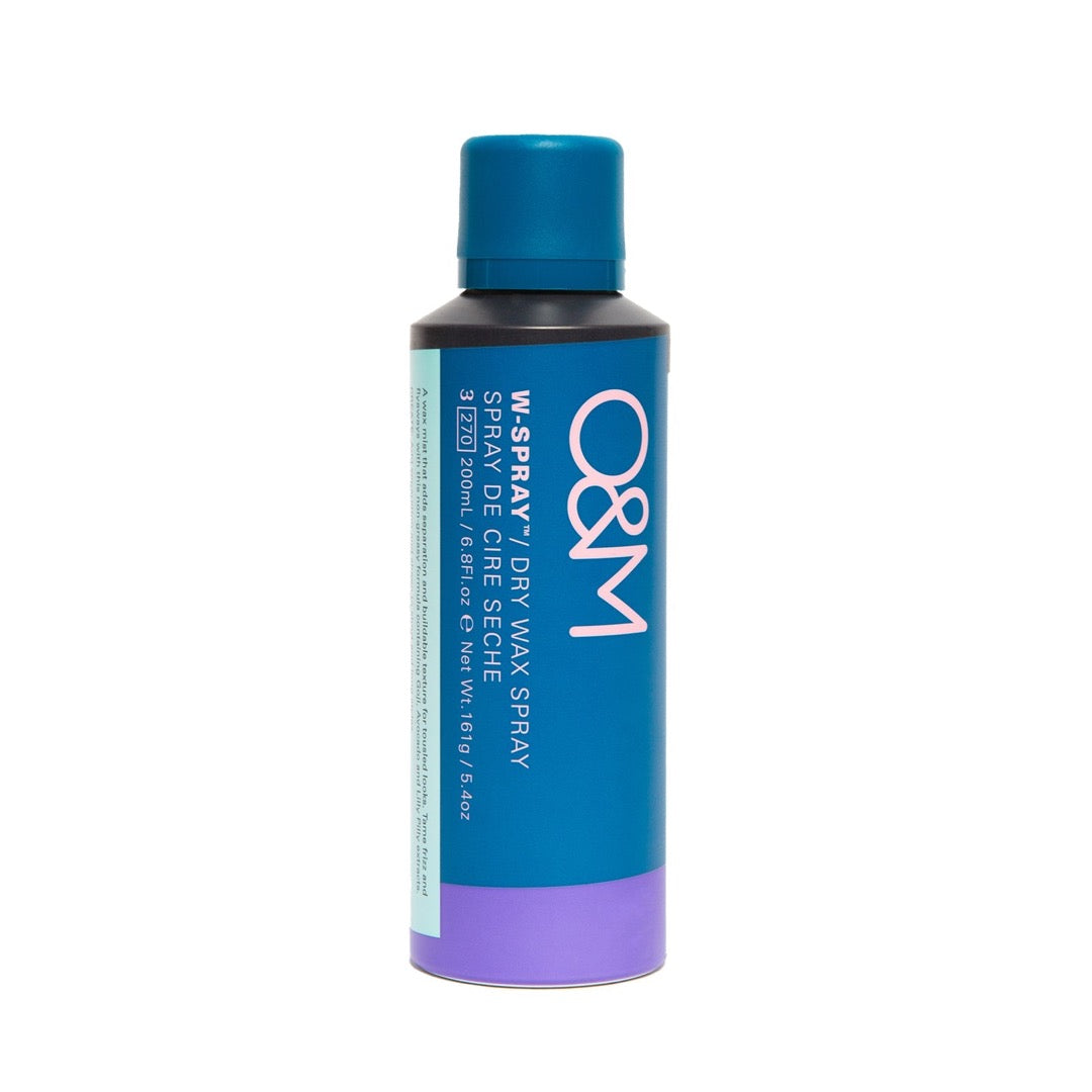 A teal aerosol can with a blue cap, labeled "O&M W-Spray Dry Wax Spray," featuring a purple base and white text, designed for hair styling.