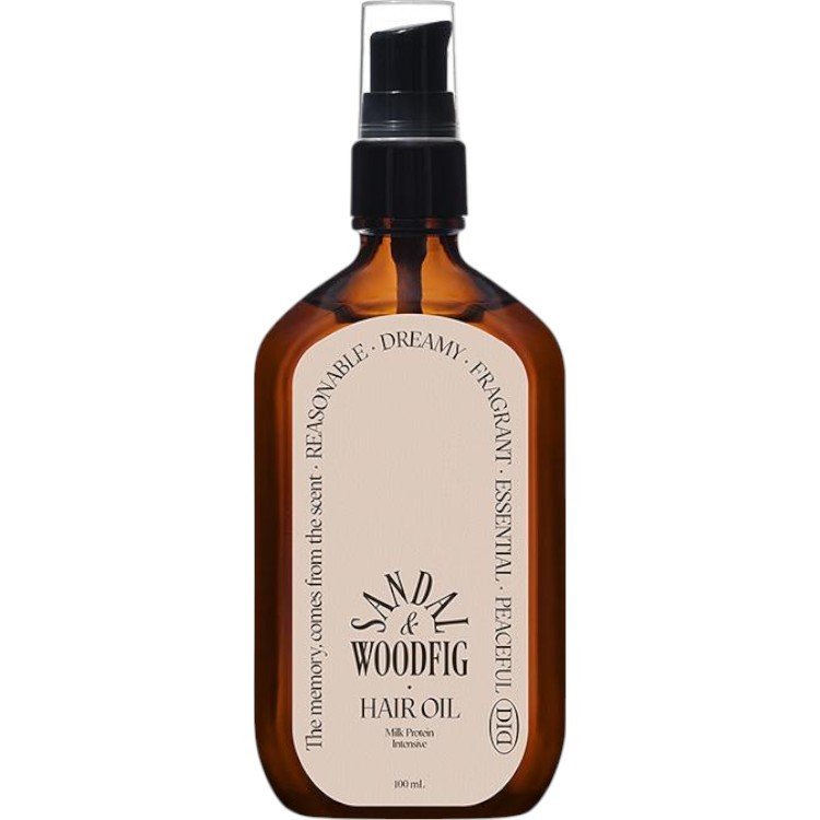 Amber glass bottle with a black spray nozzle, labeled "SANDAL & WOODFIG HAIR OIL," featuring a cream-colored label with elegant text, emphasizing a soothing and fragrant formula.