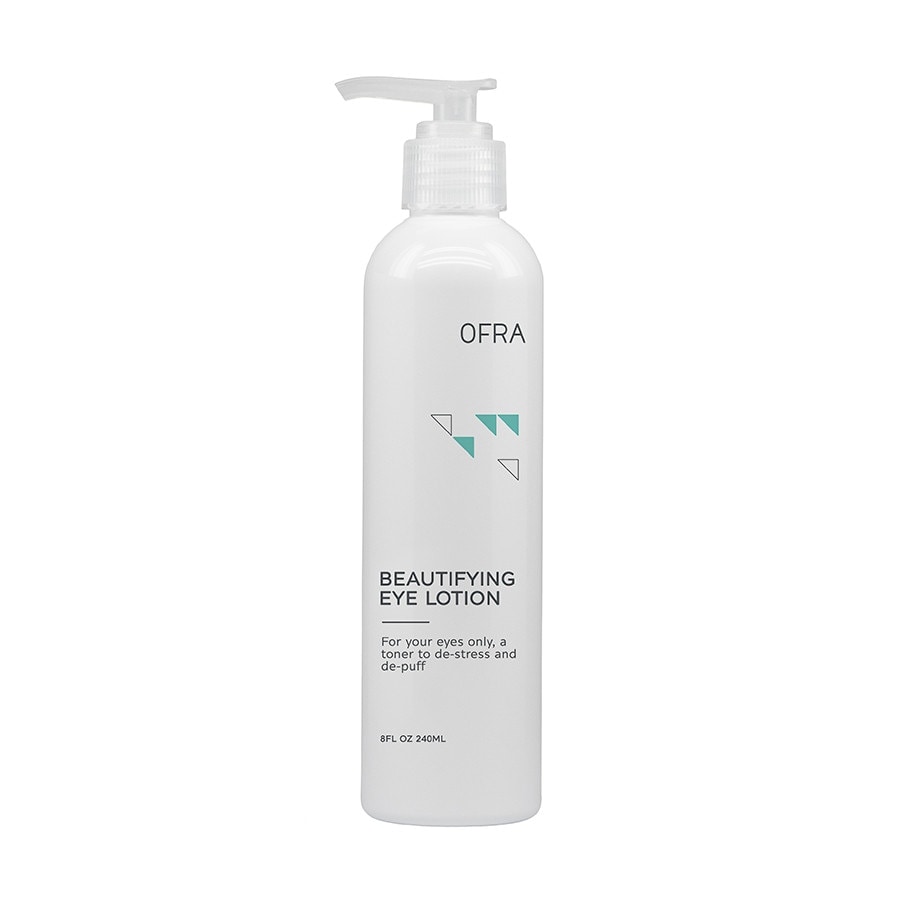 White bottle with a pump top, labeled "OFRA Beautifying Eye Lotion," featuring turquoise geometric accents and text detailing its purpose for de-stressing and de-puffing the eyes.