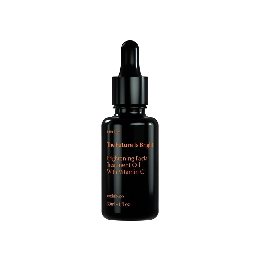 Black glass dropper bottle with a sleek design, featuring gold text that reads "The Future Is Bright Brightening Facial Oil with Vitamin C," 30ml size.