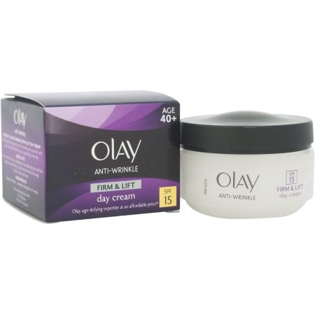 White cream jar with a silver lid beside a purple and black box labeled "Olay Anti-Wrinkle Firm & Lift Day Cream" with SPF 15, designed for ages 40 and up.
