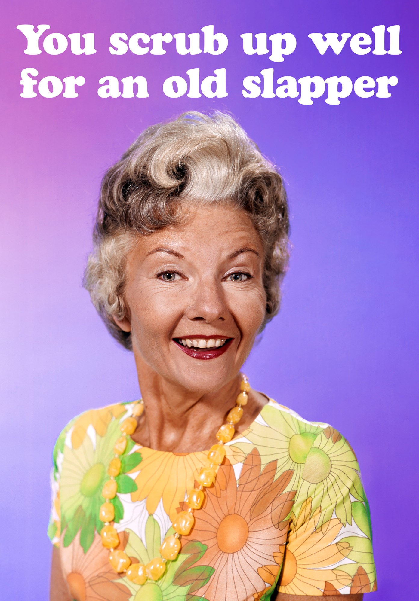 A vintage-style greeting card featuring a smiling woman with curly gray hair, wearing a colorful floral dress and a yellow necklace, with a purple gradient background and humorous text.