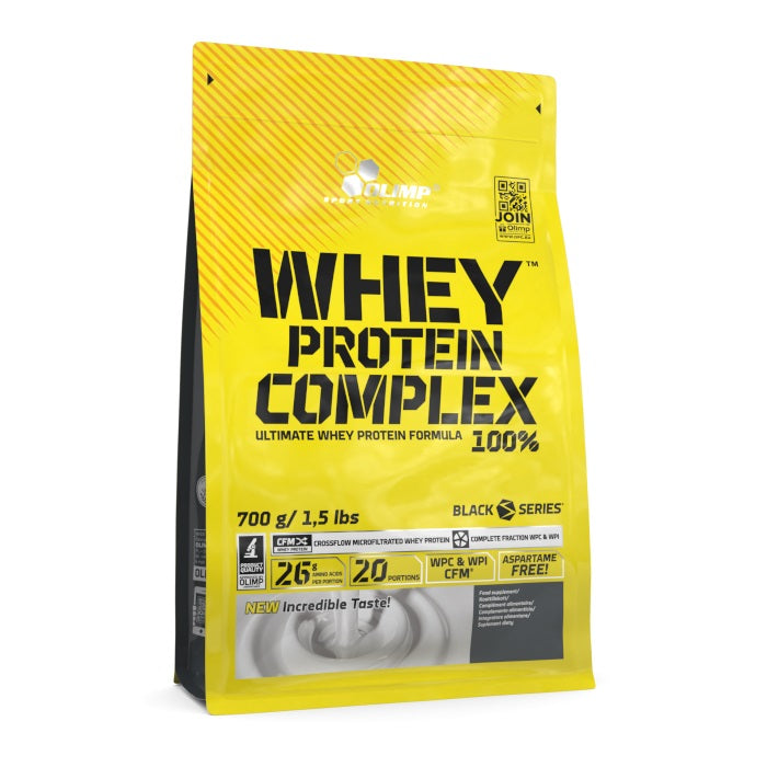 Bright yellow packaging of Olimp Whey Protein Complex 100% with a black label, featuring "Apple Pie" flavor, 700g weight, and key nutritional information prominently displayed.