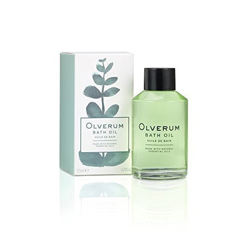 Clear glass bottle of Olverum Bath Oil (125ml) with a black cap, featuring a green liquid inside, alongside a light green and white box with botanical illustrations.