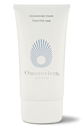 White tube of Omorovicza Cleansing Foam with a blue sunburst logo, featuring a flip-top cap and labeled with "Cleansing Foam 30 Ml" in elegant typography.